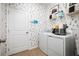 Dog-themed laundry room featuring a washer, dryer, and playful wallpaper at 2547 Great Heron Ave, St Cloud, FL 34773