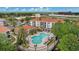 Aerial view of apartments complex with pool, deck chairs, mature trees and landscaping at 2549 Maitland Crossing Way # 306, Orlando, FL 32810