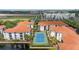 Beautiful aerial view of community featuring a tennis court, pond, and terracotta roofs at 2549 Maitland Crossing Way # 306, Orlando, FL 32810