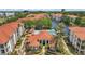 Aerial view of community buildings, landscaping, and pool with lake in the background at 2549 Maitland Crossing Way # 306, Orlando, FL 32810