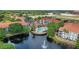 An aerial view of a condo community with a pool and pond with fountain feature at 2549 Maitland Crossing Way # 306, Orlando, FL 32810