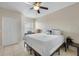 Cozy bedroom features a queen-sized bed, ceiling fan, neutral paint, and tiled floor at 2549 Maitland Crossing Way # 306, Orlando, FL 32810