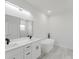 Elegant bathroom featuring dual vanity, modern fixtures, and a standalone tub at 2596 Sw 146 St, Ocala, FL 34473