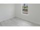 A bedroom featuring light wood-look flooring and a bright window at 2596 Sw 146 St, Ocala, FL 34473