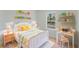 A sunny bedroom featuring a bed, desk, and bookshelves at 2596 Sw 146 St, Ocala, FL 34473