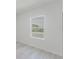 A bright bedroom featuring a large window and light wood-look floors at 2596 Sw 146 St, Ocala, FL 34473