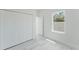 A bright bedroom with a window, closet, and light-colored wood floors at 2596 Sw 146 St, Ocala, FL 34473