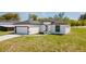 View of the home's exterior, showing the lawn and the driveway at 2596 Sw 146 St, Ocala, FL 34473