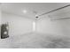 Bright garage featuring sealed concrete flooring and white concrete block walls at 2596 Sw 146 St, Ocala, FL 34473