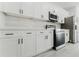 Bright kitchen with modern appliances, white cabinetry and light backsplash at 2596 Sw 146 St, Ocala, FL 34473