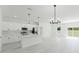 Modern kitchen with white cabinetry, stainless steel appliances, and a center island overlooking the living area at 2596 Sw 146 St, Ocala, FL 34473