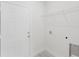 Bright laundry room with white door, wire rack, and hookups at 2596 Sw 146 St, Ocala, FL 34473
