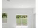 Bright living room with view to green trees from the window at 2596 Sw 146 St, Ocala, FL 34473