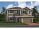 Charming two-story home featuring a welcoming front door, attached two car garage and manicured lawn at 2666 Great Heron Ave, St Cloud, FL 34773