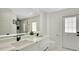 Bright bathroom offers double sinks, a large mirror, and a glass-enclosed shower at 2685 Groveland Ave, Deltona, FL 32725