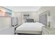 Well-lit bedroom with TV features a plush, tufted bed frame, complementing dressers and a crib at 2685 Groveland Ave, Deltona, FL 32725