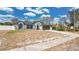Charming single-story home boasts a two-car garage, neutral paint scheme and well-manicured landscaping at 2685 Groveland Ave, Deltona, FL 32725