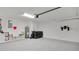 Spacious garage with speckled floor, water heater, and modern washer and dryer at 2685 Groveland Ave, Deltona, FL 32725