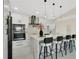 Modern kitchen with stainless steel appliances, a marble island with seating and modern pendant lighting at 2685 Groveland Ave, Deltona, FL 32725