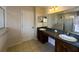 Bathroom featuring dual sinks, tile flooring, and a glass shower enclosure at 2840 Roccella Ct, Kissimmee, FL 34747