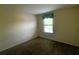 Neutral bedroom featuring plush carpeting and a sunlit window at 2840 Roccella Ct, Kissimmee, FL 34747