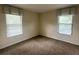 Neutral bedroom features plush carpeting and two sunlit windows at 2840 Roccella Ct, Kissimmee, FL 34747