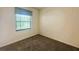 Cozy bedroom featuring neutral walls, carpet flooring, and a bright window with blinds at 2840 Roccella Ct, Kissimmee, FL 34747