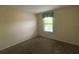 Cozy bedroom featuring neutral walls, carpet flooring, and a bright window with blinds at 2840 Roccella Ct, Kissimmee, FL 34747