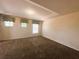 Spacious bedroom with plush carpeting, three windows, and tray ceiling at 2840 Roccella Ct, Kissimmee, FL 34747