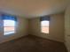 Bedroom featuring carpeted floors, and two windows providing natural light at 2840 Roccella Ct, Kissimmee, FL 34747
