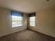 Bedroom with two windows offers plenty of natural light and a comfortable carpeted floor at 2840 Roccella Ct, Kissimmee, FL 34747