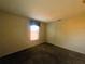 Bedroom with a window, plush carpeting, and neutral walls, offering a serene space at 2840 Roccella Ct, Kissimmee, FL 34747