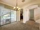 Dining room with chandelier lighting and access to kitchen and living spaces at 2840 Roccella Ct, Kissimmee, FL 34747