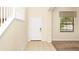 Foyer with tile flooring, white door, and carpeted stairs at 2840 Roccella Ct, Kissimmee, FL 34747
