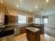 Well-lit kitchen with wooden cabinets, stainless steel appliances, and tiled floor at 2840 Roccella Ct, Kissimmee, FL 34747