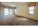 Spacious living room featuring a large window and sliding glass door leading to a pool at 2840 Roccella Ct, Kissimmee, FL 34747