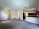Open-concept living room with a view of the kitchen and hallway, features neutral color palette at 2840 Roccella Ct, Kissimmee, FL 34747