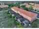 Aerial perspective of townhomes featuring screened patios, lush landscaping, and tidy grounds at 3020 Red Ginger Rd, Kissimmee, FL 34747