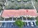 Aerial view of townhomes with red tile roofs, lush landscaping, and convenient parking at 3020 Red Ginger Rd, Kissimmee, FL 34747
