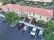 Aerial view of the townhome, parking lot, and lush landscaping at 3020 Red Ginger Rd, Kissimmee, FL 34747