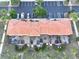 Aerial view of back of townhome highlighting screened in patios and lush landscaping at 3020 Red Ginger Rd, Kissimmee, FL 34747