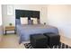The bright bedroom showcases a padded headboard, stylish rug and lots of natural light at 3020 Red Ginger Rd, Kissimmee, FL 34747