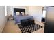 The bedroom showcases a padded headboard, stylish rug, bedside table, and large mirror at 3020 Red Ginger Rd, Kissimmee, FL 34747