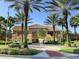 Clubhouse with palm trees and lush landscaping at 3020 Red Ginger Rd, Kissimmee, FL 34747
