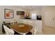 Cozy dining area featuring a wooden table, white chairs and modern lighting at 3020 Red Ginger Rd, Kissimmee, FL 34747