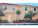 Charming two-story townhome with a red tile roof and well-manicured landscaping at 3020 Red Ginger Rd, Kissimmee, FL 34747