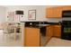 Modern kitchen with stainless steel sink, black appliances and wood cabinets at 3020 Red Ginger Rd, Kissimmee, FL 34747