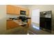 Well-equipped kitchen with modern appliances and wood cabinets at 3020 Red Ginger Rd, Kissimmee, FL 34747