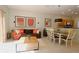 A cozy living area flowing into the dining area, with modern furnishings and tiled floors at 3020 Red Ginger Rd, Kissimmee, FL 34747