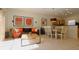 A cozy living area flowing into the dining area, with modern furnishings and tiled floors at 3020 Red Ginger Rd, Kissimmee, FL 34747